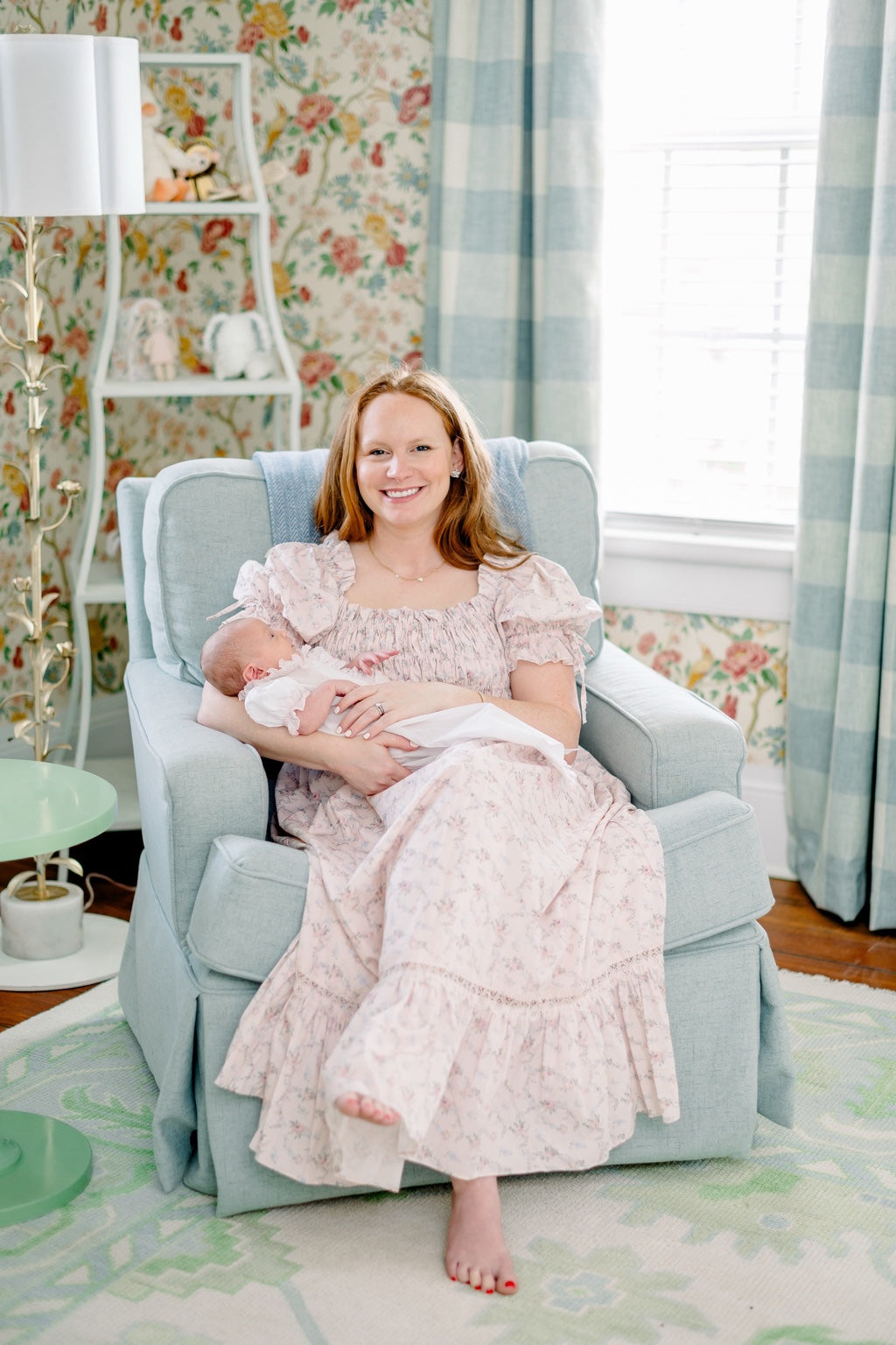 Lily holding Olivia in a powder-blue chair